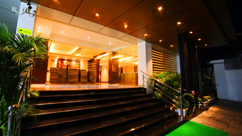 Hotel Le Lotus Grand Varanasi Varanasi [Welcoming Hotel Entrance With Glass Doors And Signage]