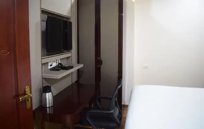 Hotel Naveen Continental Prayagraj [Comfortable Seating Area In Deluxe Room At Hotel Naveen Continental With Stylish Chairs And A Coffee Table.]