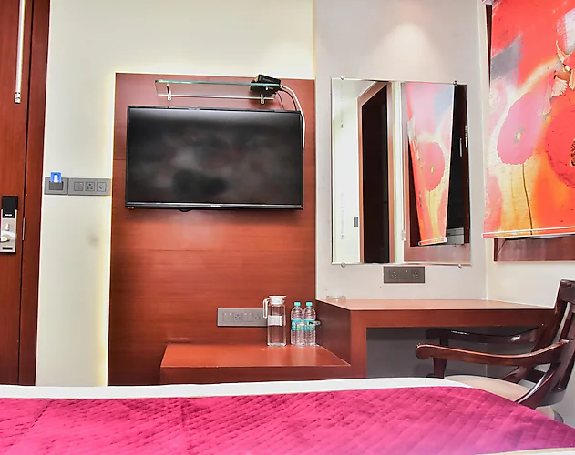 Hotel The Park View Prayagraj [Side View Of The Deluxe Room Bed At Hotel The Park View With Bedside Lamps And Modern Decor.]